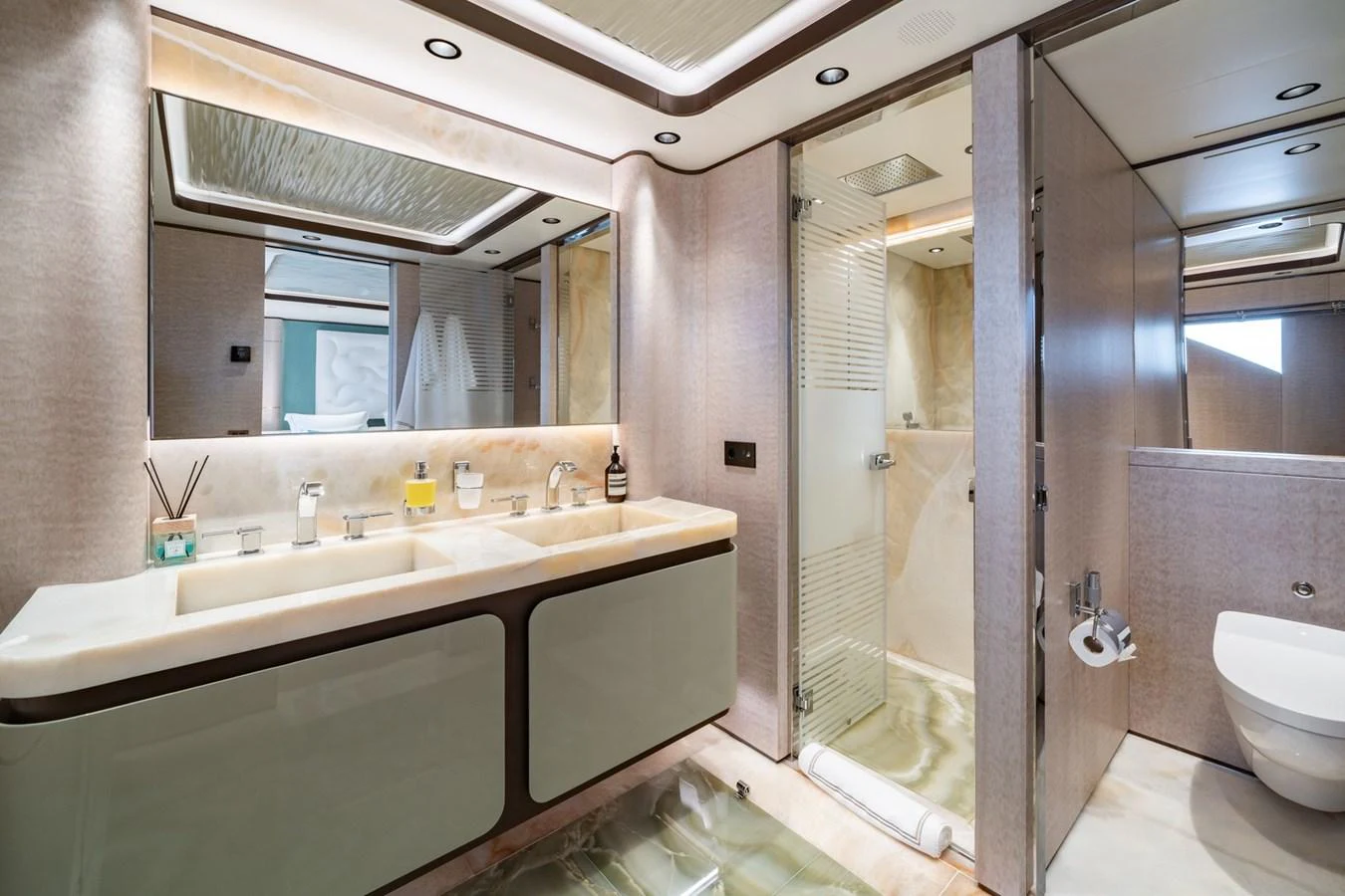 The yacht's bathroom features a luxurious double sink vanity and a spacious shower area. aboard MALIA Yacht for Sale