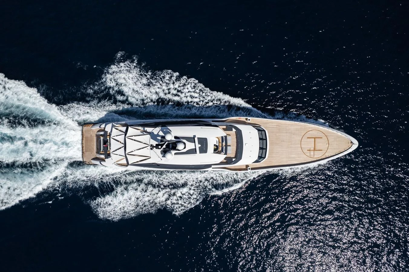 A sleek yacht cruises through the water, leaving a trail of white foam in its wake. aboard MALIA Yacht for Sale