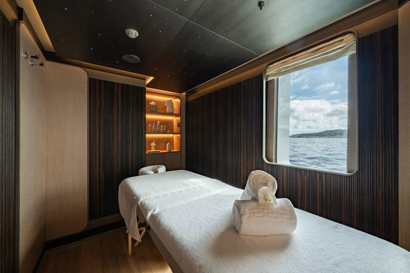 The yacht's spa room offers a serene space with massage tables and a view of the sea. aboard MALIA Yacht for Sale
