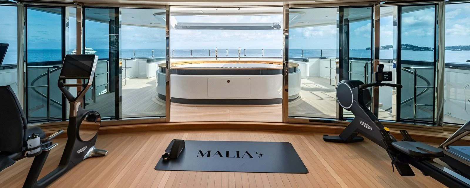 The yacht features a state-of-the-art gym with panoramic ocean views. aboard MALIA Yacht for Sale