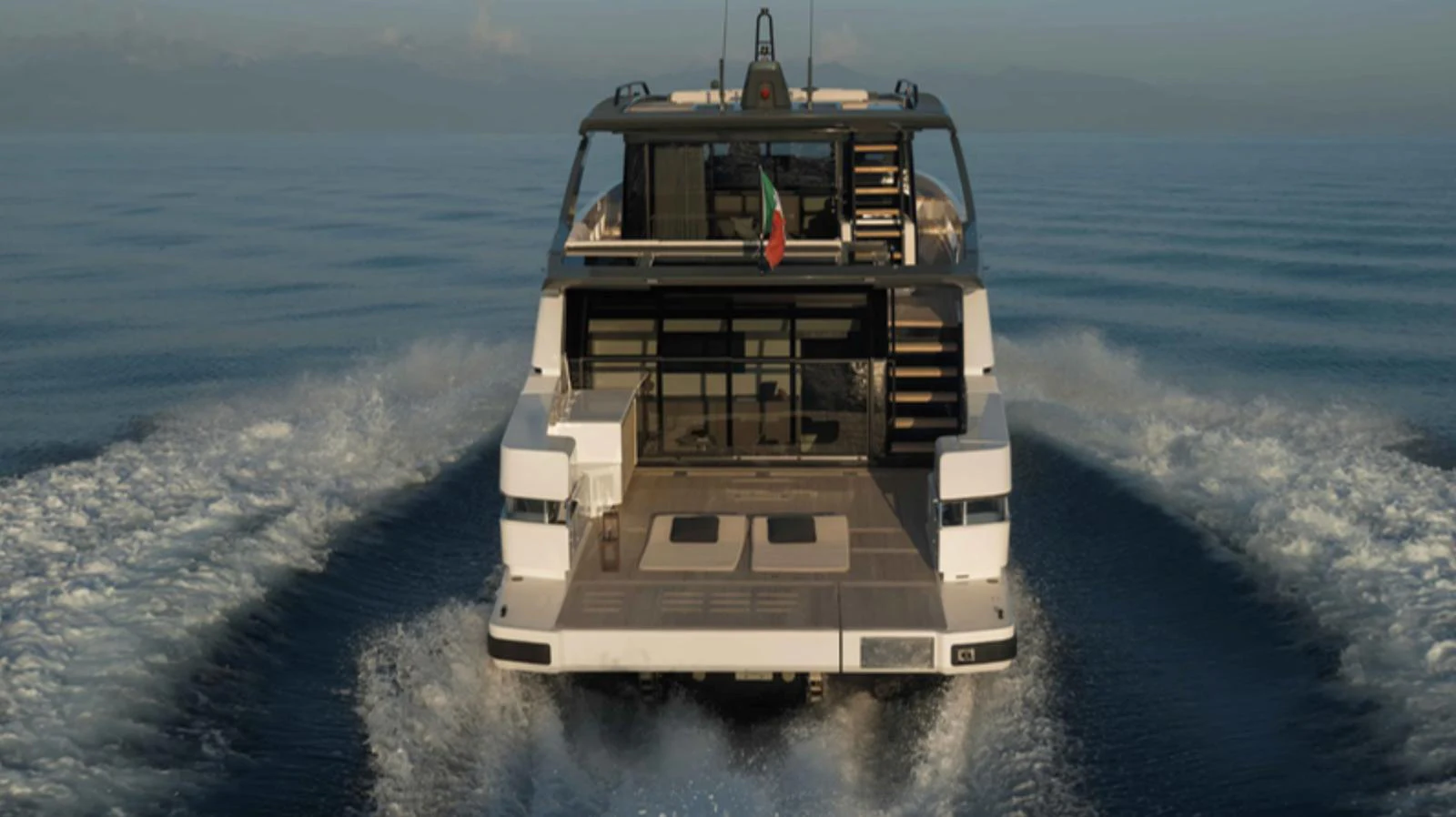 The yacht is seen from the rear, cruising smoothly on calm waters. aboard BARIC Yacht for Sale
