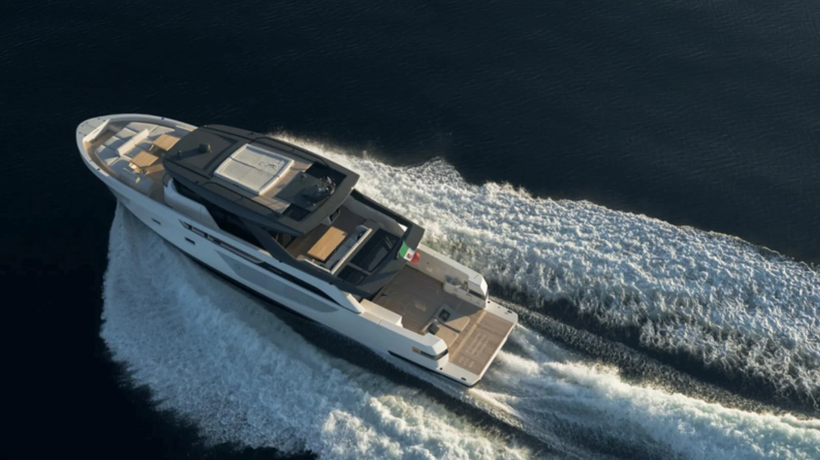 A sleek, modern yacht cruises swiftly through the water, leaving a trail of white wake behind. aboard BARIC Yacht for Sale