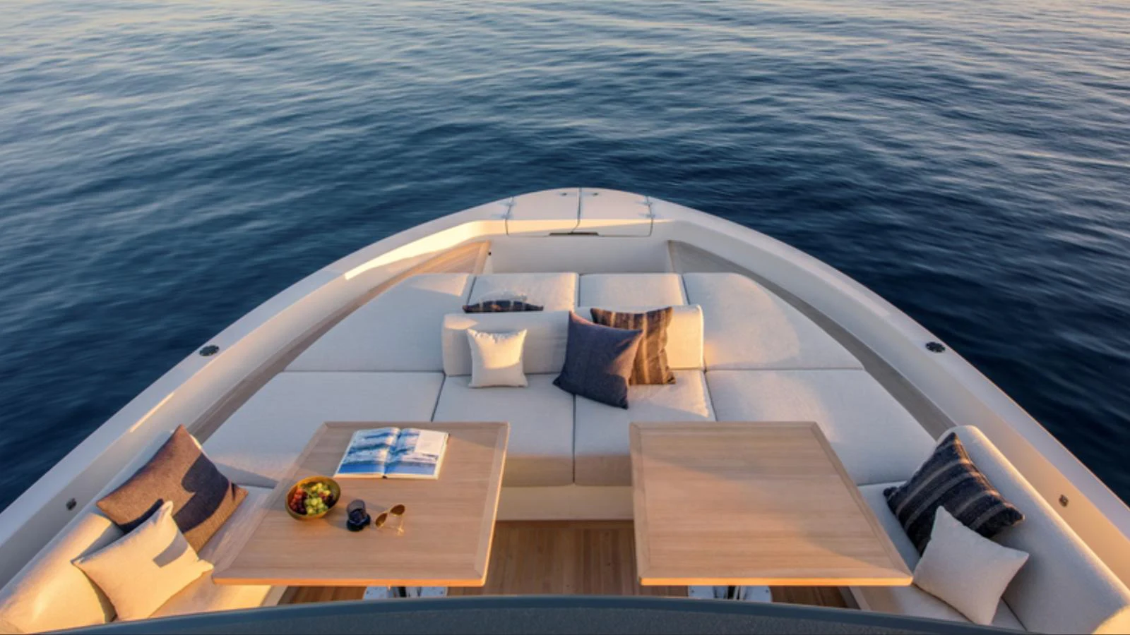 The foredeck features a luxurious lounging area with plush cushions and dual tables, perfect for relaxation and dining. aboard BARIC Yacht for Sale