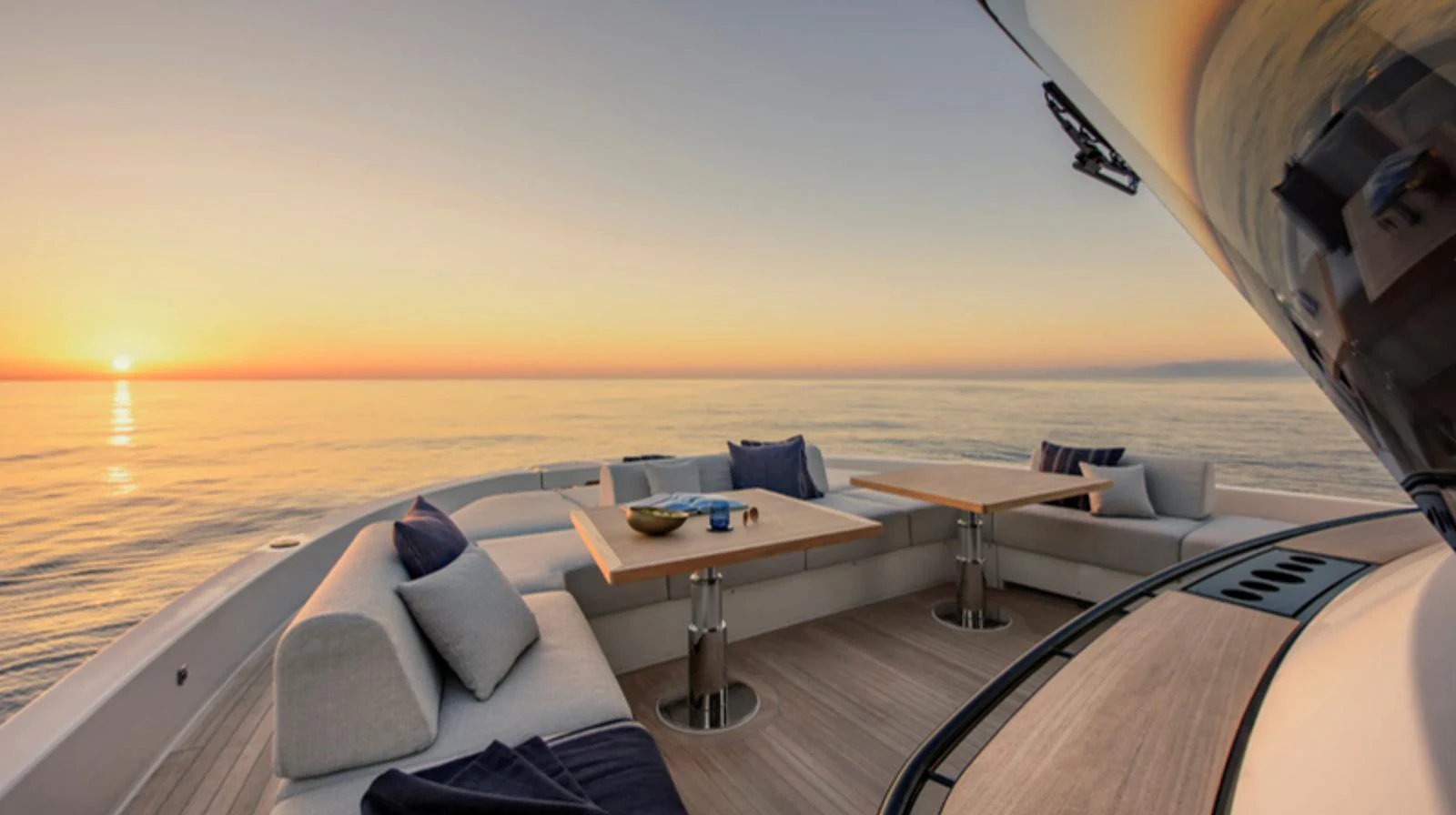The aft deck offers a serene setting with comfortable seating and tables, perfect for enjoying the sunset over the water. aboard BARIC Yacht for Sale