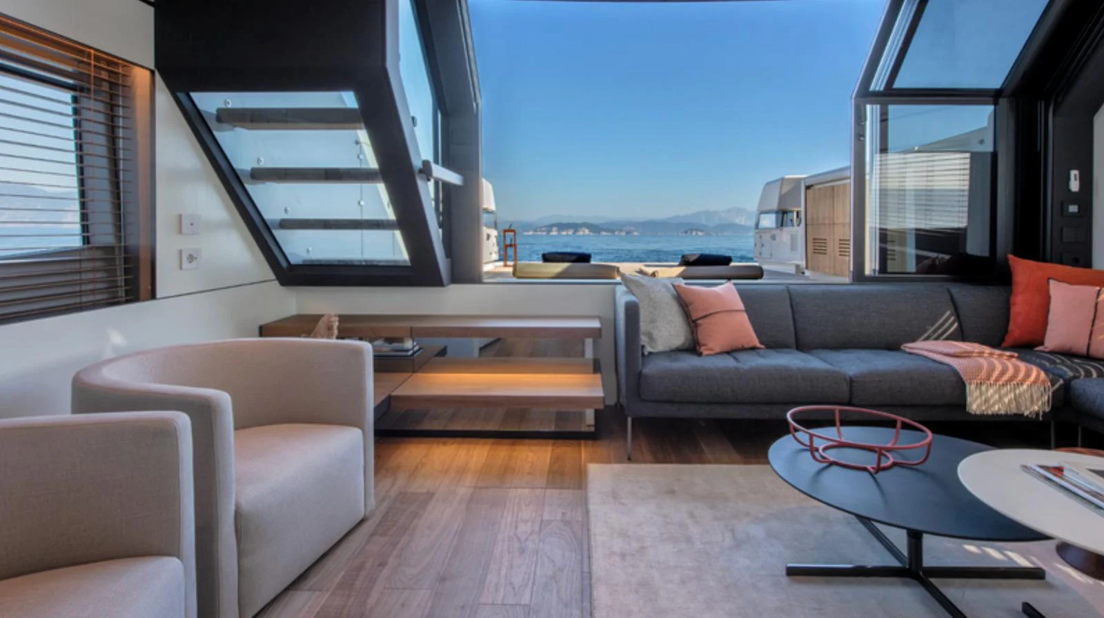 A modern and spacious yacht interior with comfortable seating and large windows offering stunning views. aboard BARIC Yacht for Sale