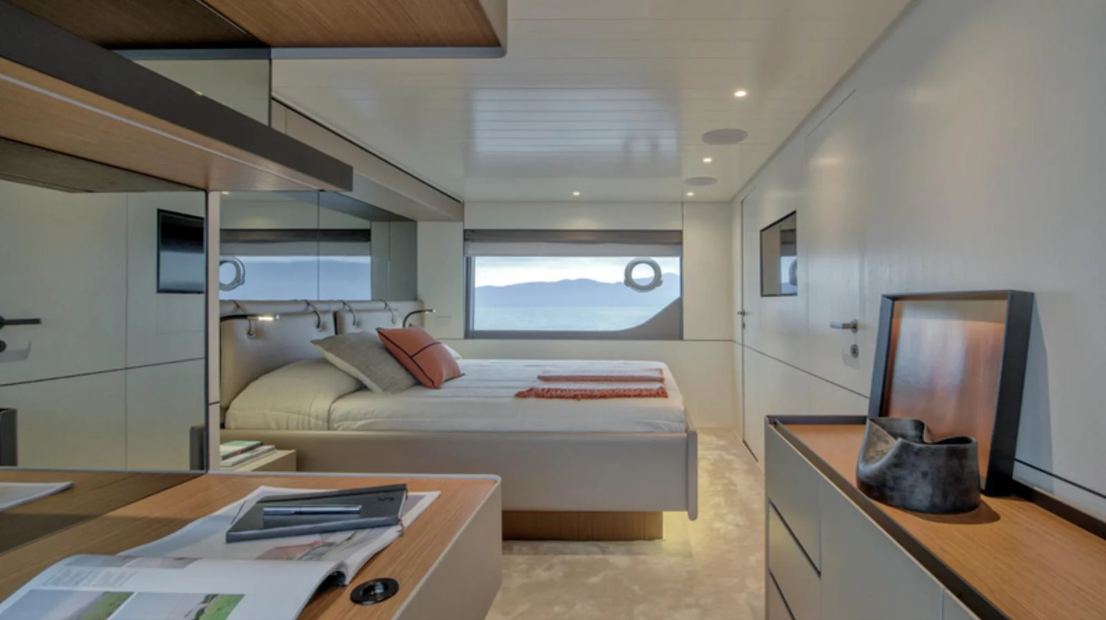A modern stateroom with a large bed and scenic window views. aboard BARIC Yacht for Sale