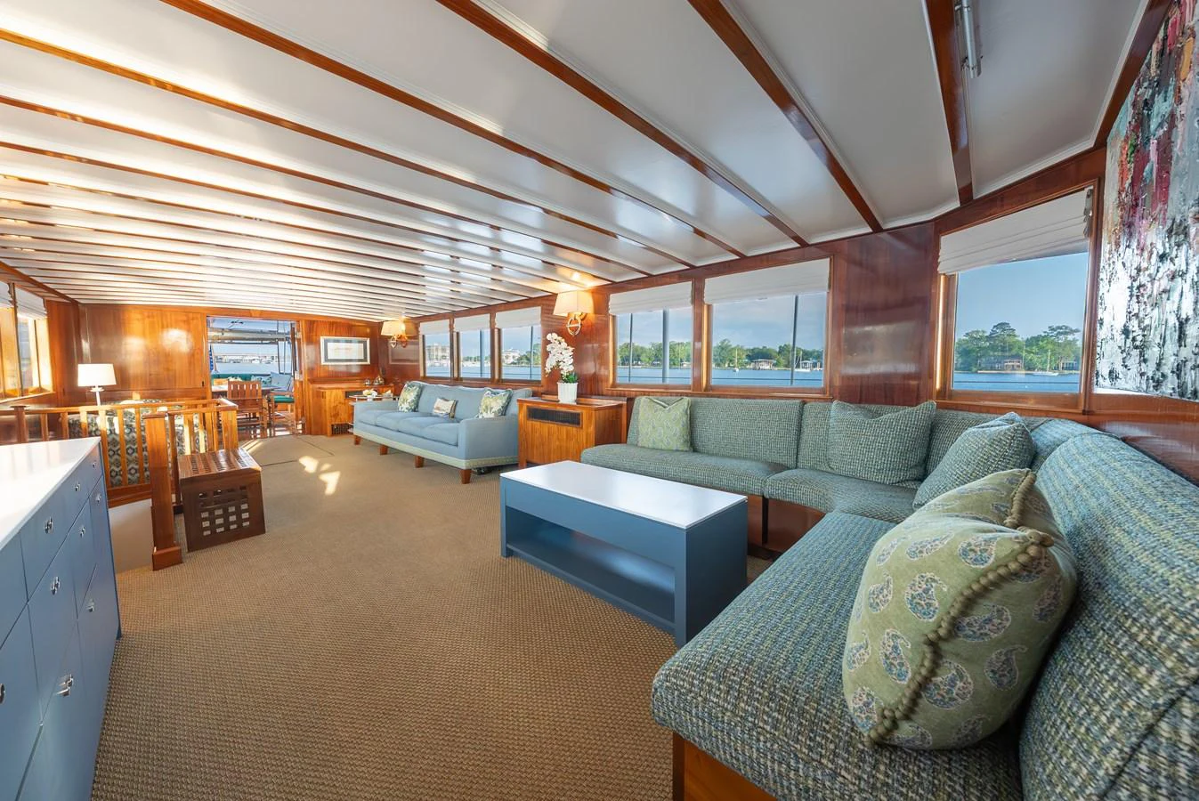 The salon features comfortable seating with ample natural light and panoramic views. aboard INNISFAIL Yacht for Sale