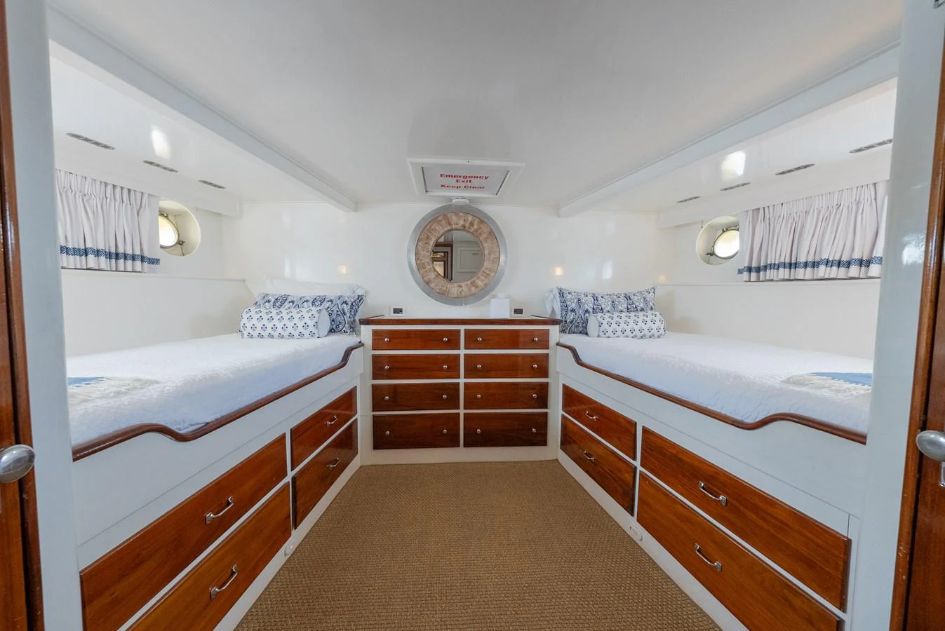 The guest stateroom features twin beds, ample storage, and a nautical decor. aboard INNISFAIL Yacht for Sale