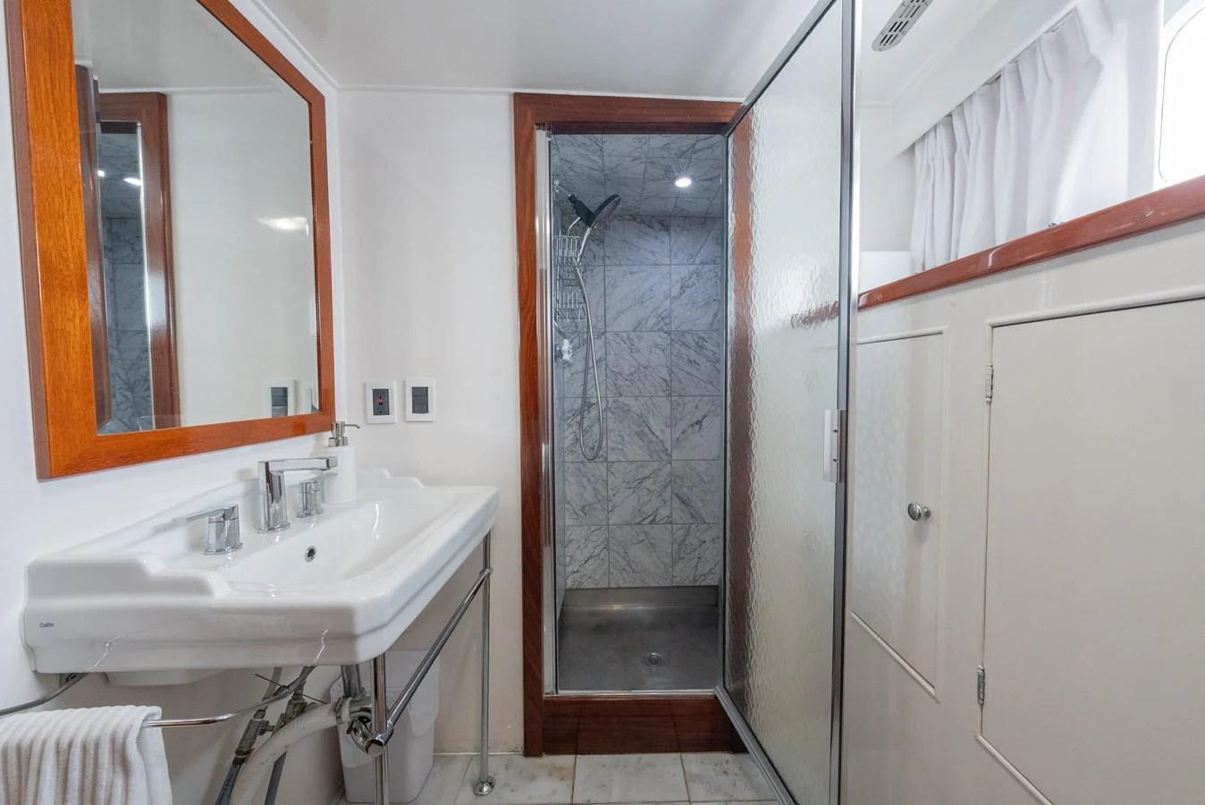 The yacht's bathroom features a sleek design with a spacious shower and modern fixtures. aboard INNISFAIL Yacht for Sale