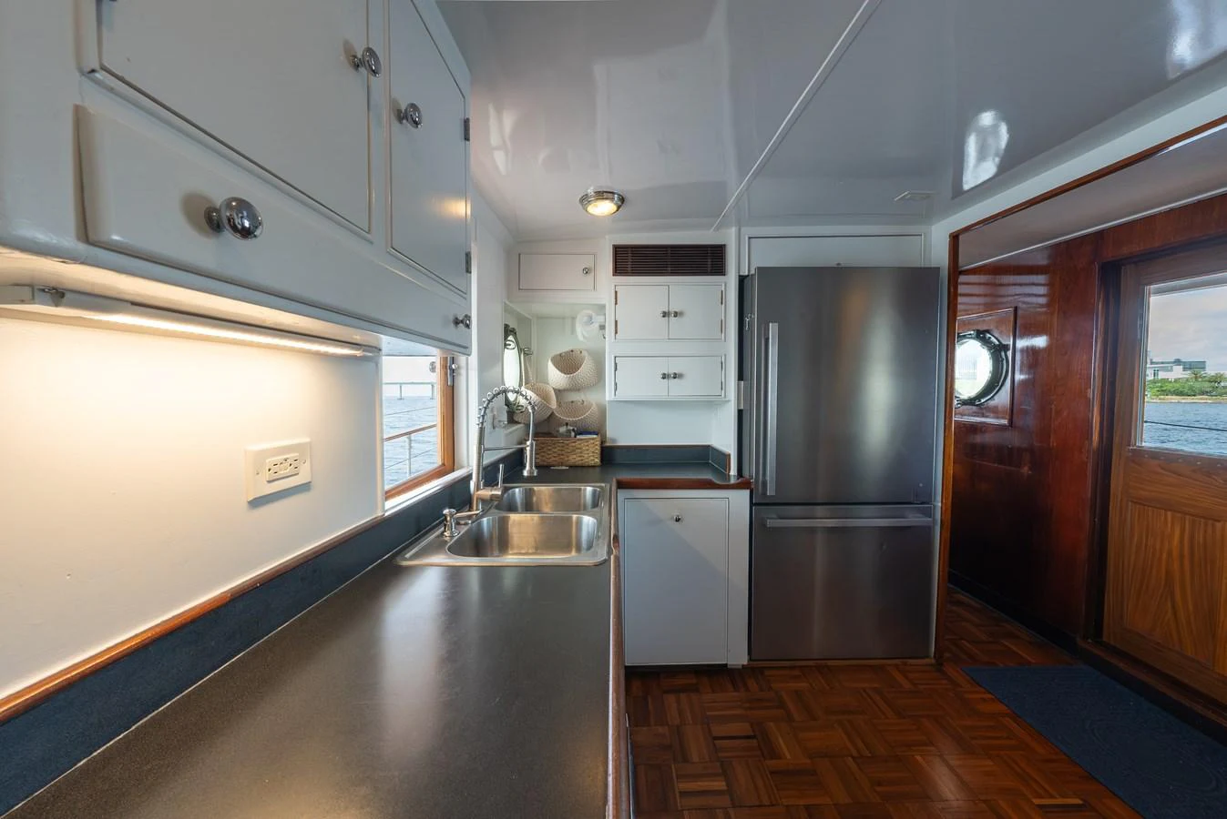 The galley features sleek countertops, modern appliances, and ample storage space, creating a functional and stylish cooking area. aboard INNISFAIL Yacht for Sale