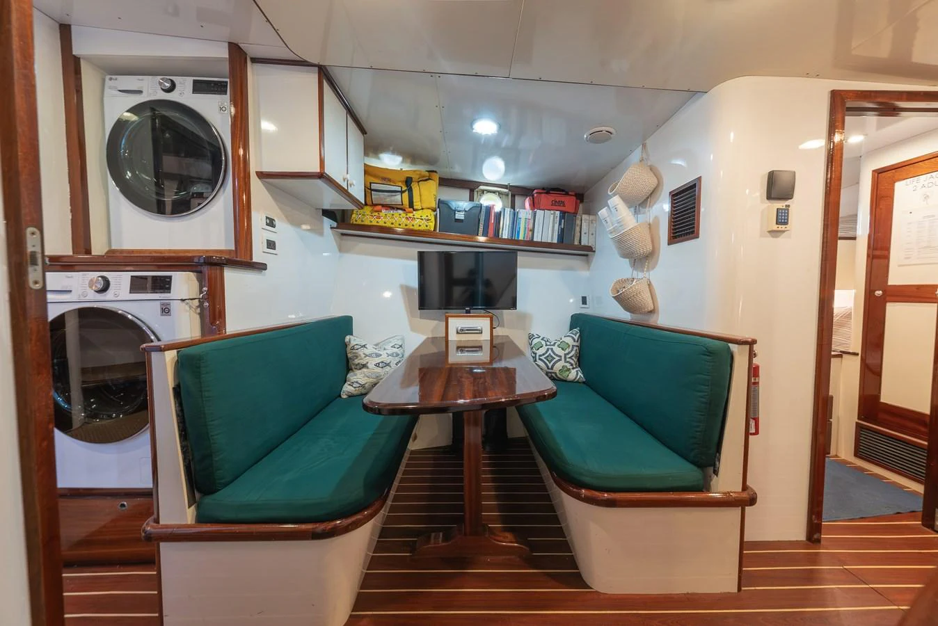 The cozy dining area features comfortable seating and modern amenities, perfect for relaxed meals on board. aboard INNISFAIL Yacht for Sale