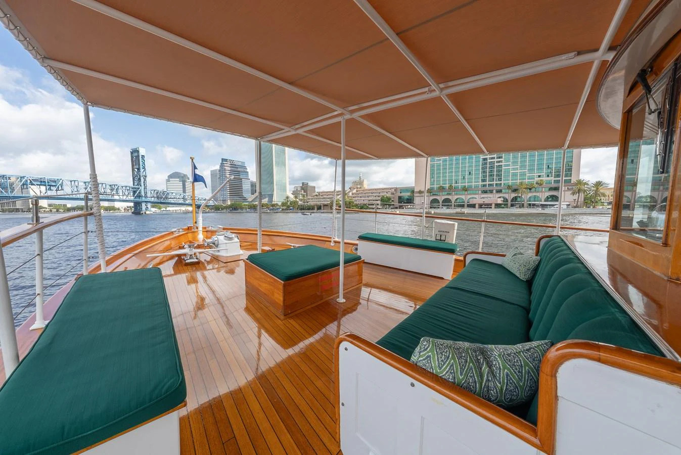 The aft deck features comfortable seating with a scenic view of the city skyline. aboard INNISFAIL Yacht for Sale