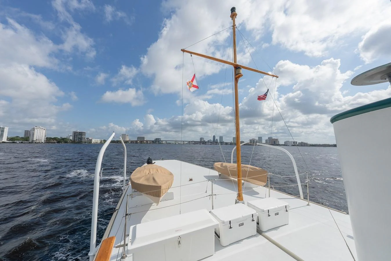 The yacht's deck offers a spacious and open view of the surrounding waters and cityscape. aboard INNISFAIL Yacht for Sale