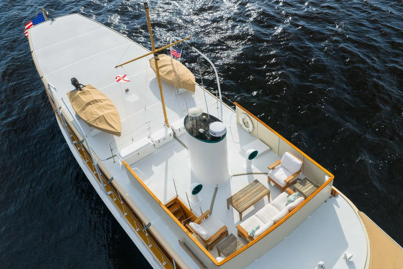 The yacht's sundeck offers a serene space with comfortable seating and a view of the open water. aboard INNISFAIL Yacht for Sale