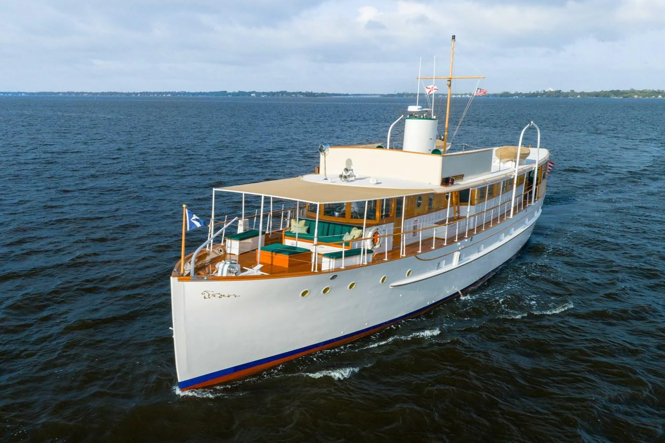 A classic yacht cruises gracefully on calm waters, showcasing its elegant design and timeless charm. aboard INNISFAIL Yacht for Sale