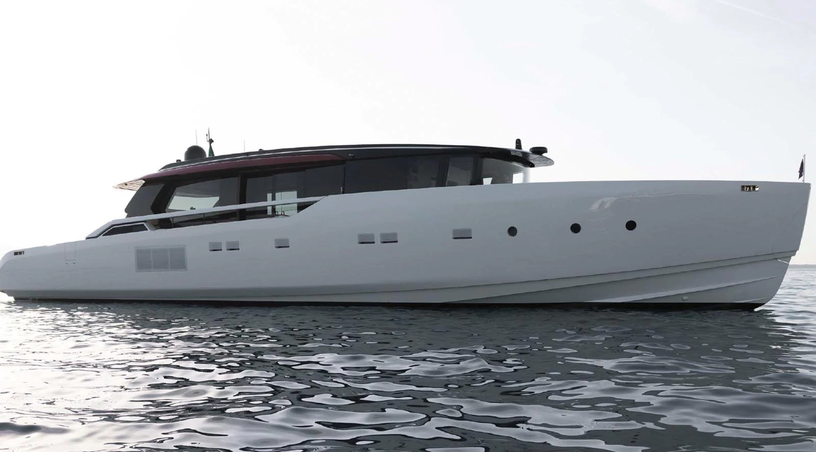A sleek and modern yacht glides gracefully on calm waters. aboard STEEL IT Yacht for Sale