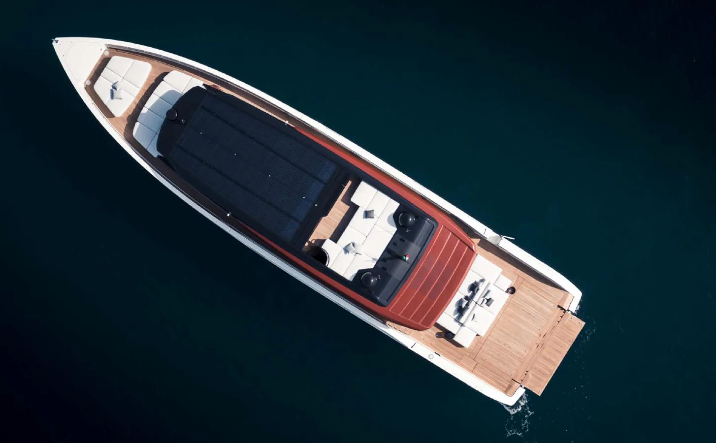 A sleek yacht with a modern design is seen from an aerial view, showcasing its spacious deck and elegant lines. aboard STEEL IT Yacht for Sale