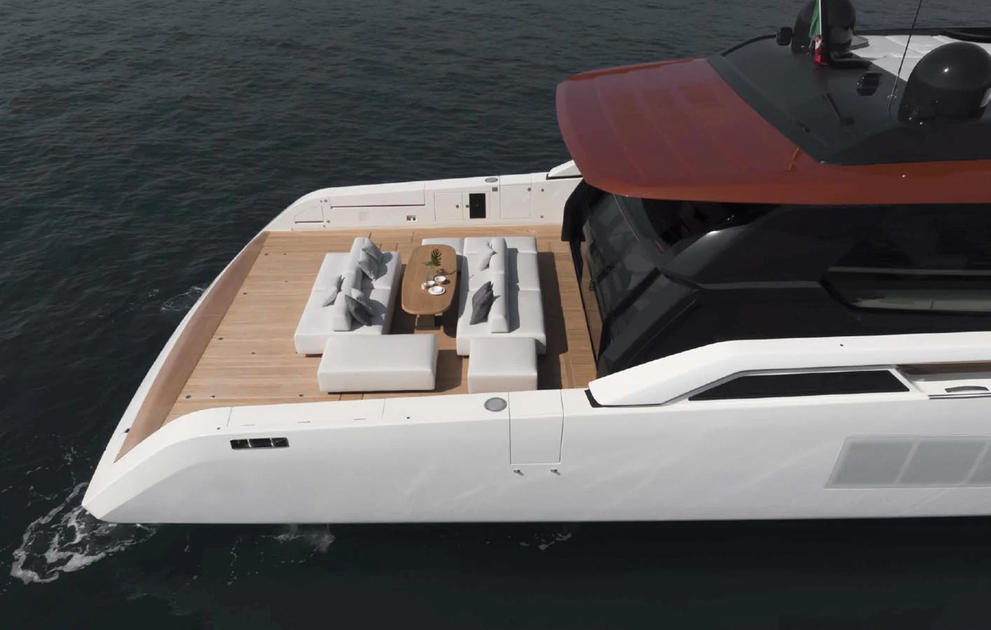 The yacht's sleek aft deck features a stylish seating area with a central table, perfect for relaxation and socializing. aboard STEEL IT Yacht for Sale
