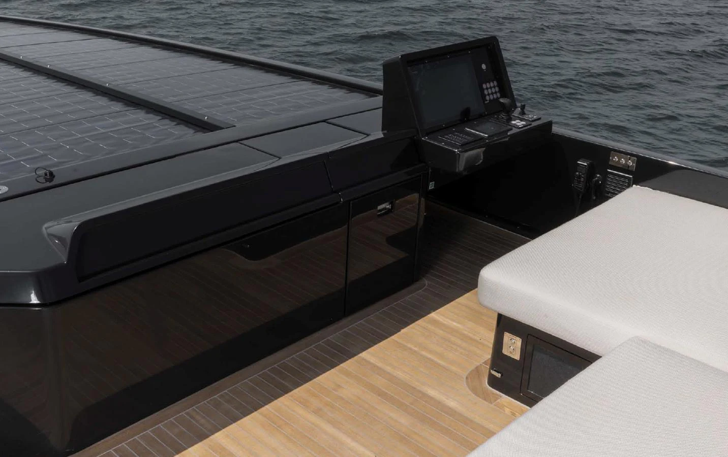 A sleek control panel and lounging area on the deck of a modern yacht. aboard STEEL IT Yacht for Sale