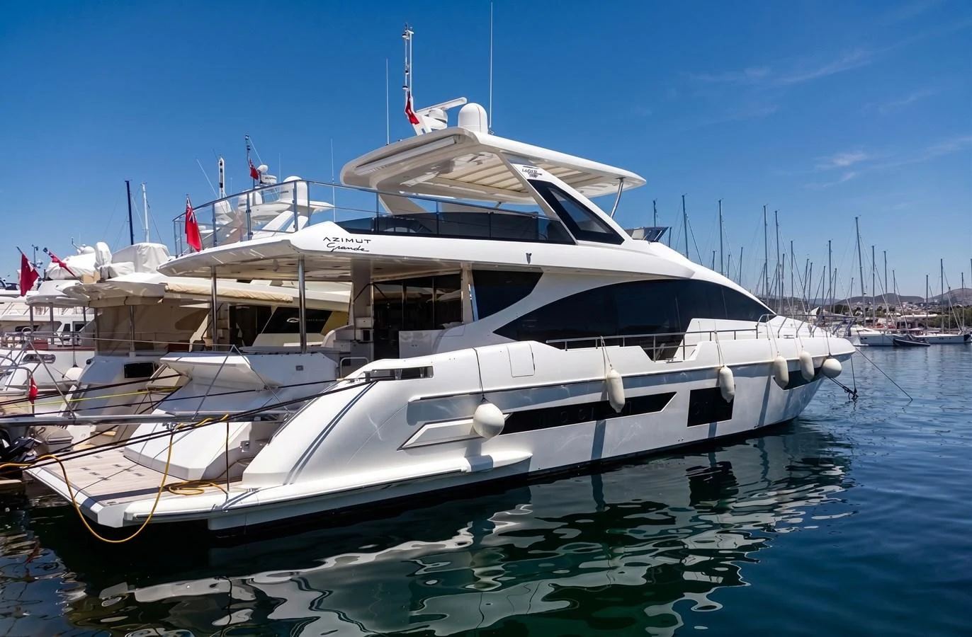 A sleek and modern yacht is docked at a marina, showcasing its elegant design and luxurious features. aboard LIL Yacht for Sale