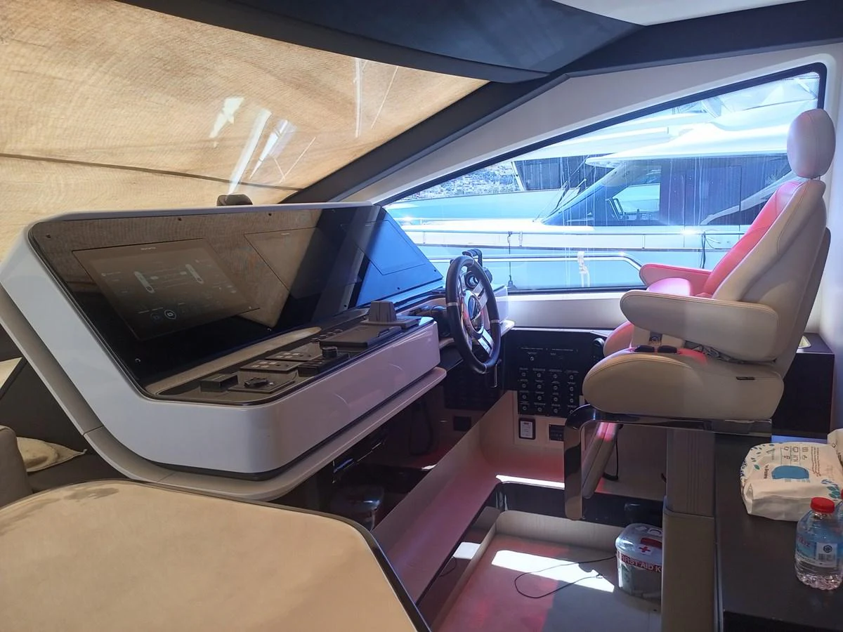 The helm station features advanced navigation equipment and a comfortable captain's chair. aboard LIL Yacht for Sale