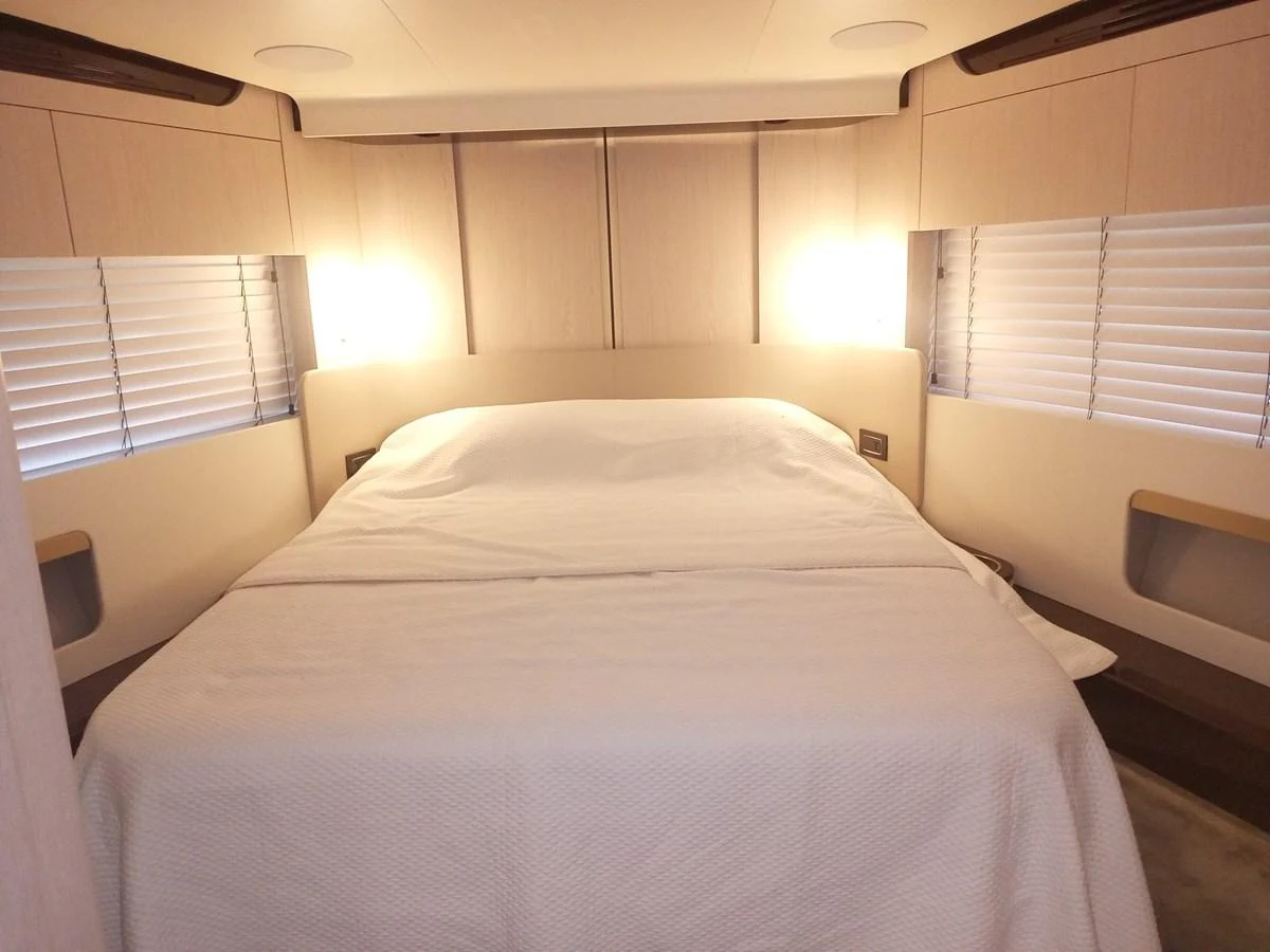 A cozy stateroom with a large bed and ambient lighting. aboard LIL Yacht for Sale