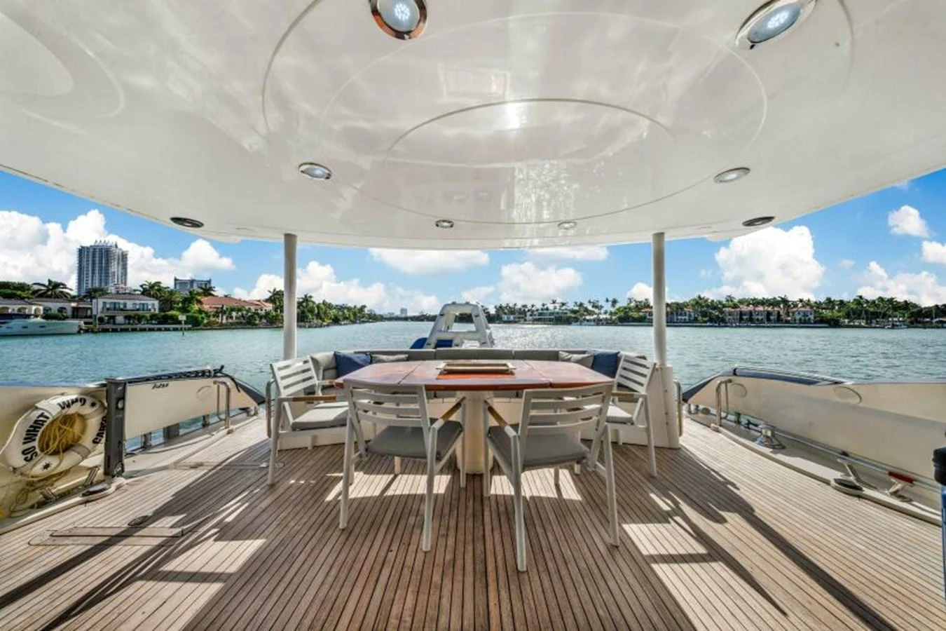 The aft deck features a spacious seating area with a table, perfect for outdoor dining and relaxation. aboard SO WHAT WHO CARES Yacht for Sale