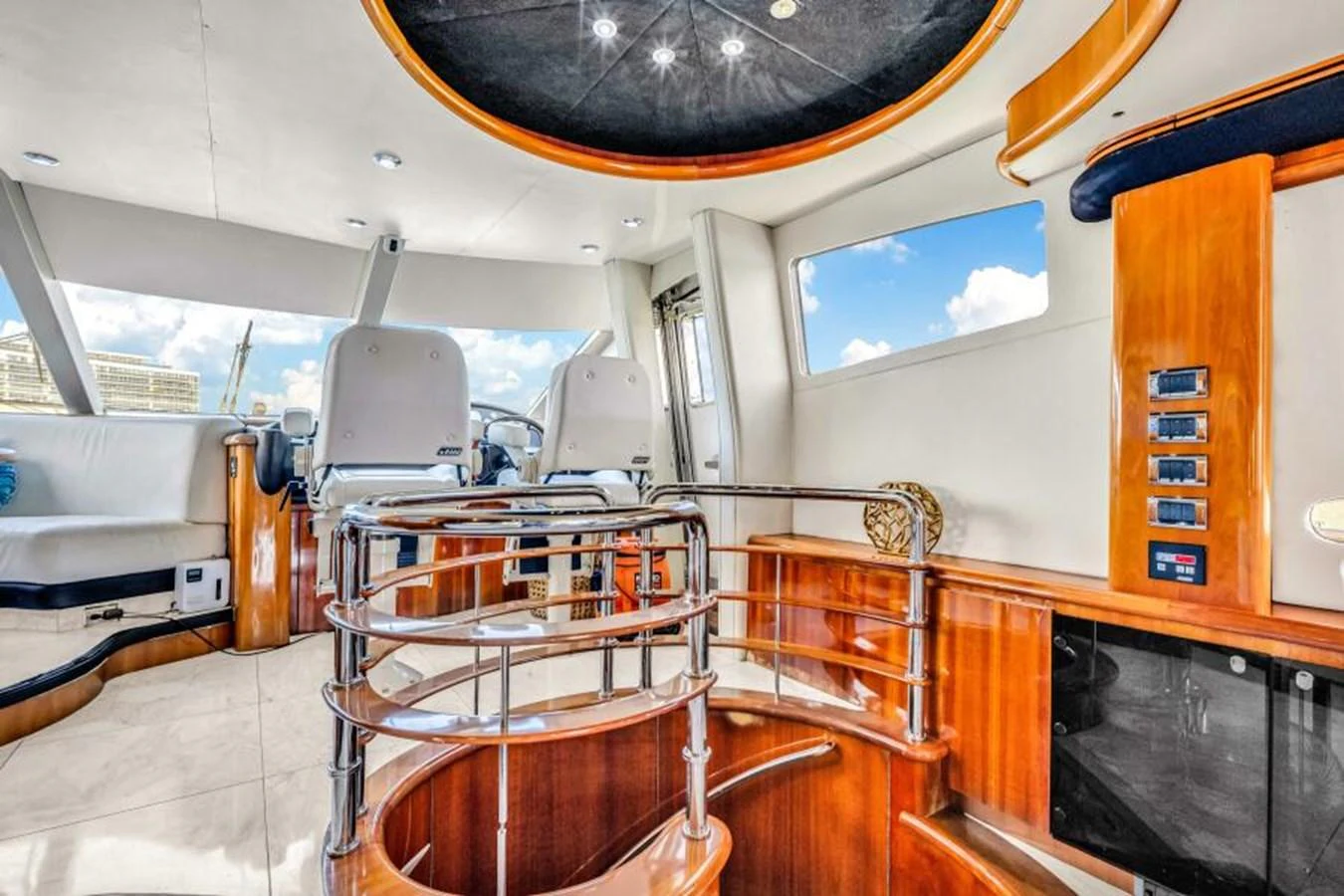 The helm area features luxurious wood finishes and modern seating. aboard SO WHAT WHO CARES Yacht for Sale