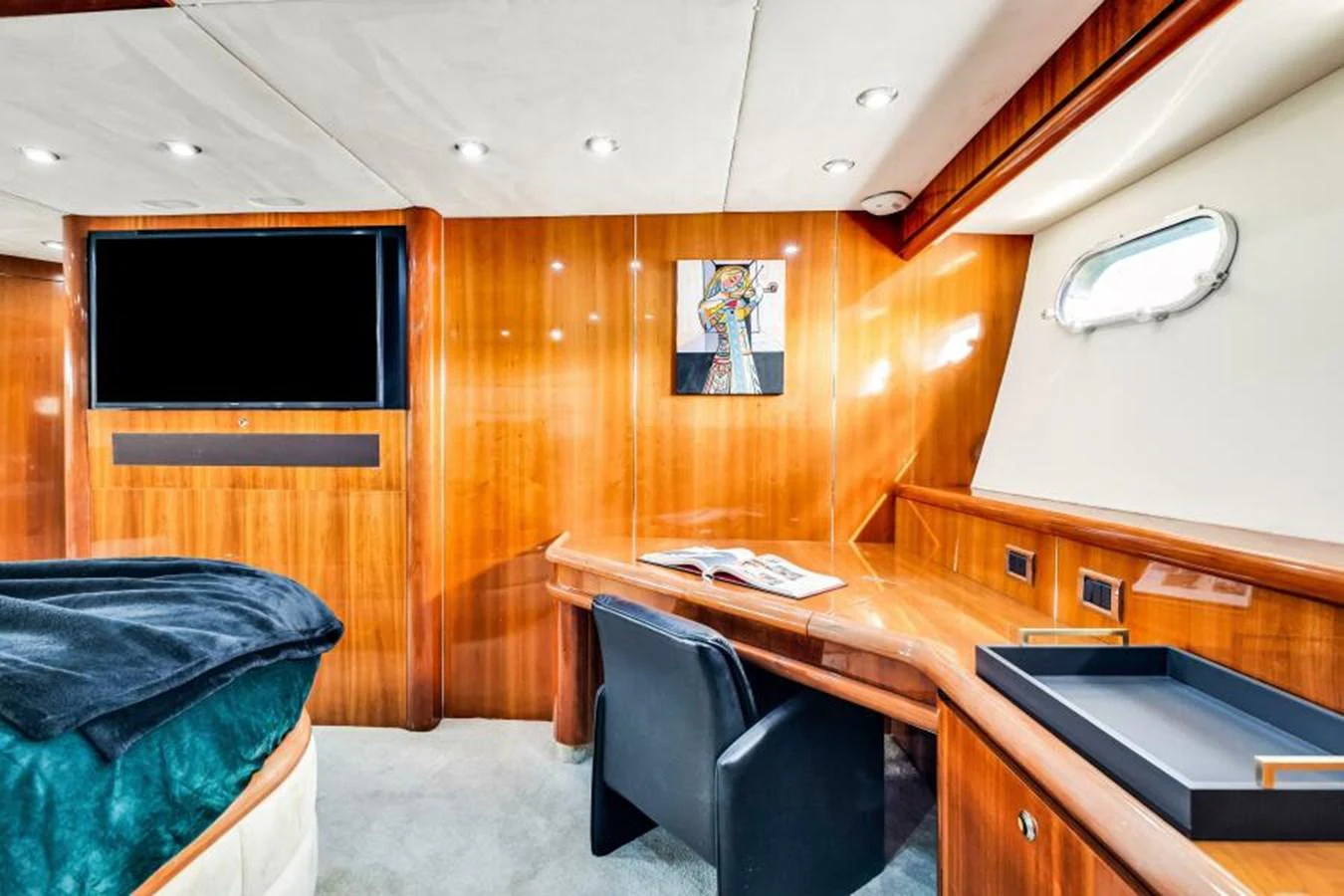 The stateroom features a cozy workspace with a desk and a comfortable chair. aboard SO WHAT WHO CARES Yacht for Sale