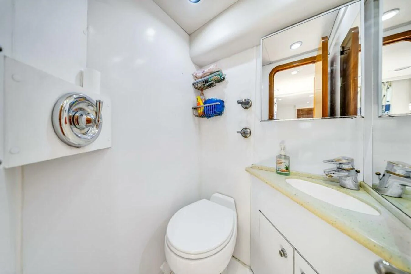 A compact and well-appointed yacht bathroom featuring modern fixtures and ample storage. aboard SO WHAT WHO CARES Yacht for Sale