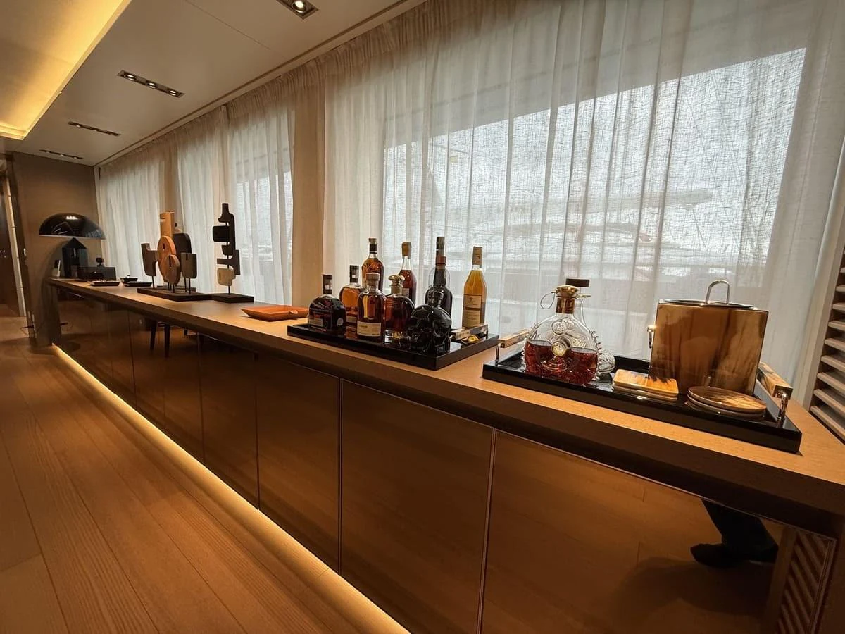 A luxurious interior bar area with a variety of premium beverages and elegant decor. aboard PHOENICIAN Yacht for Sale