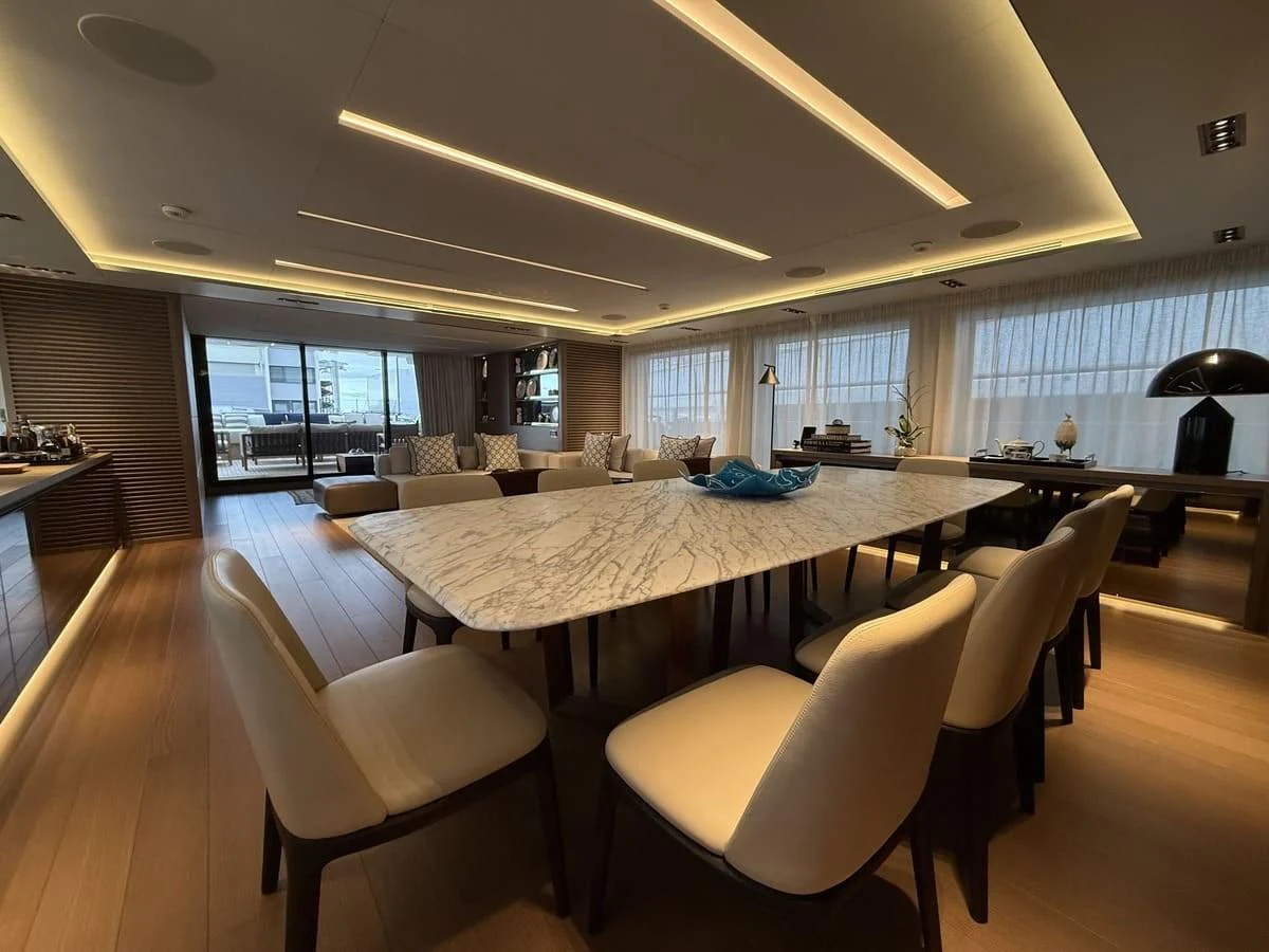 The yacht's dining area features a luxurious marble table and comfortable seating, creating an inviting space for meals and gatherings. aboard PHOENICIAN Yacht for Sale