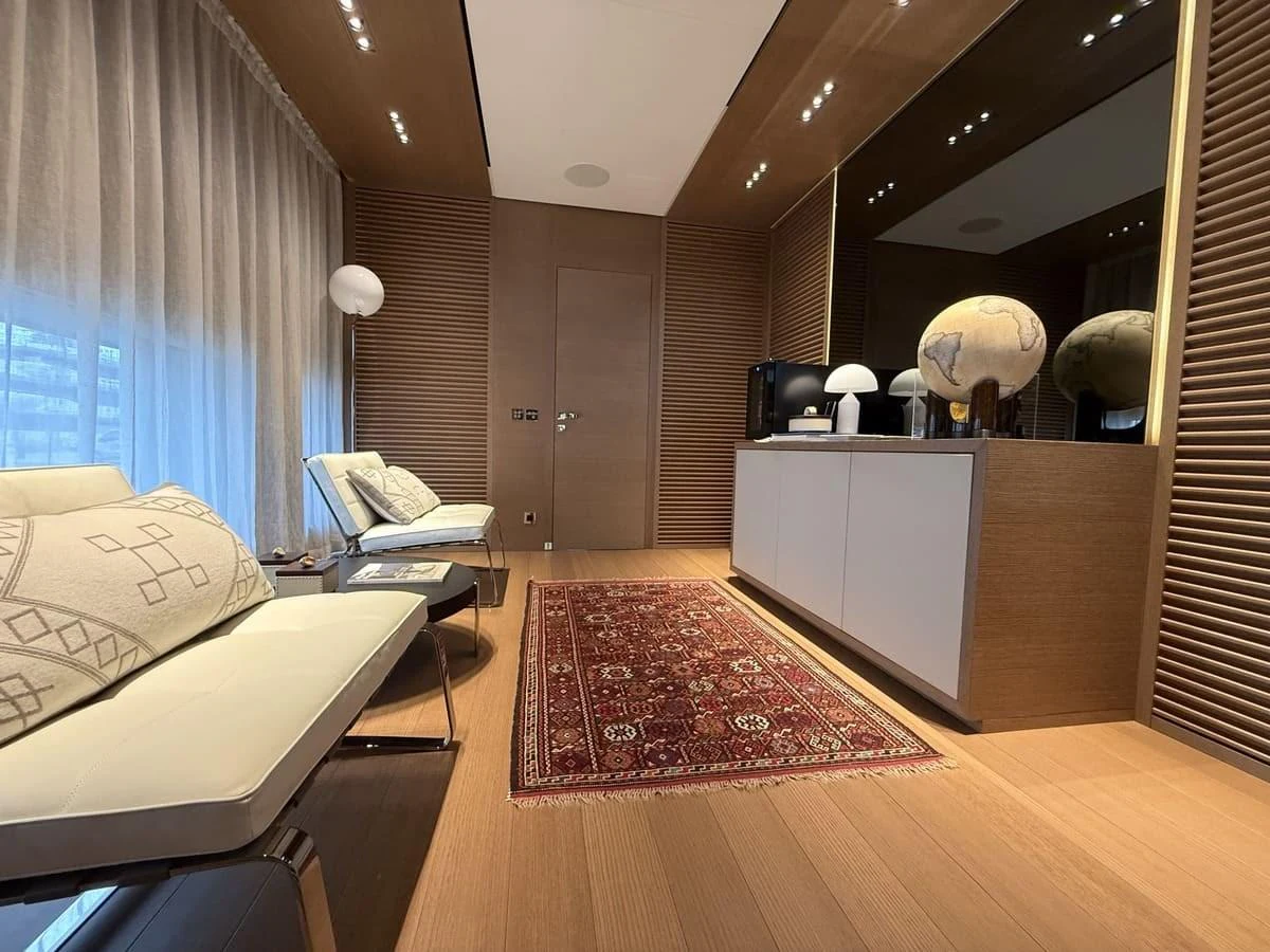 The yacht's interior features a cozy seating area with elegant decor and warm lighting. aboard PHOENICIAN Yacht for Sale