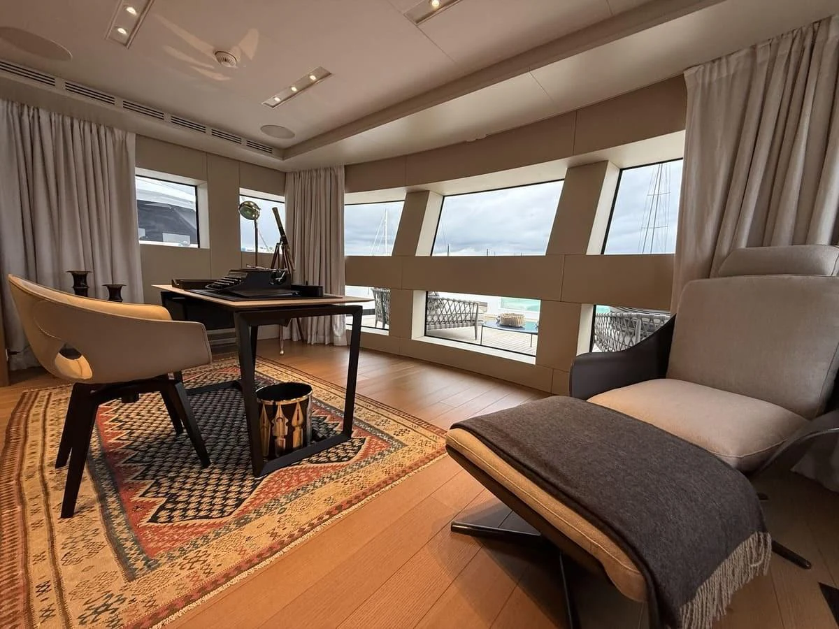A luxurious yacht office space with modern furnishings and large windows offering ample natural light. aboard PHOENICIAN Yacht for Sale