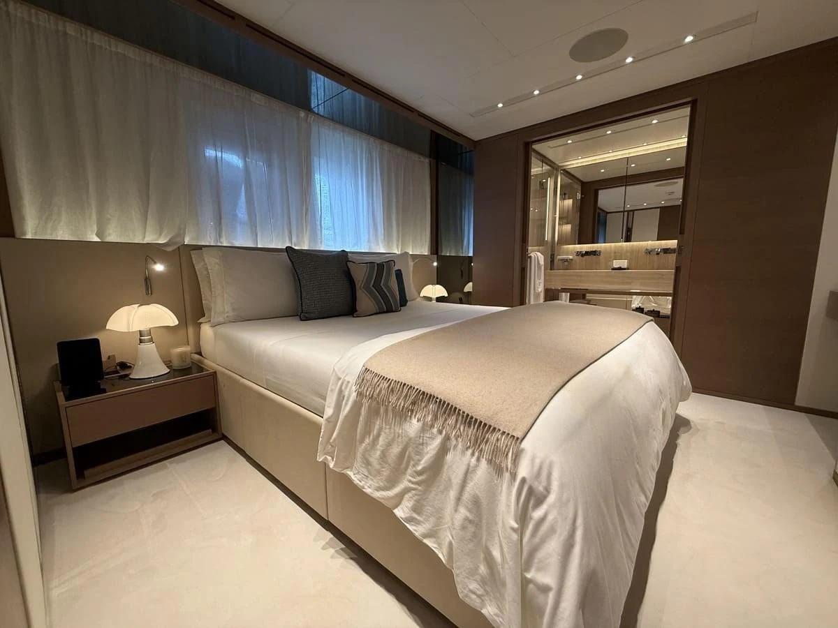 The stateroom offers a luxurious and serene sleeping area with elegant decor and soft lighting. aboard PHOENICIAN Yacht for Sale