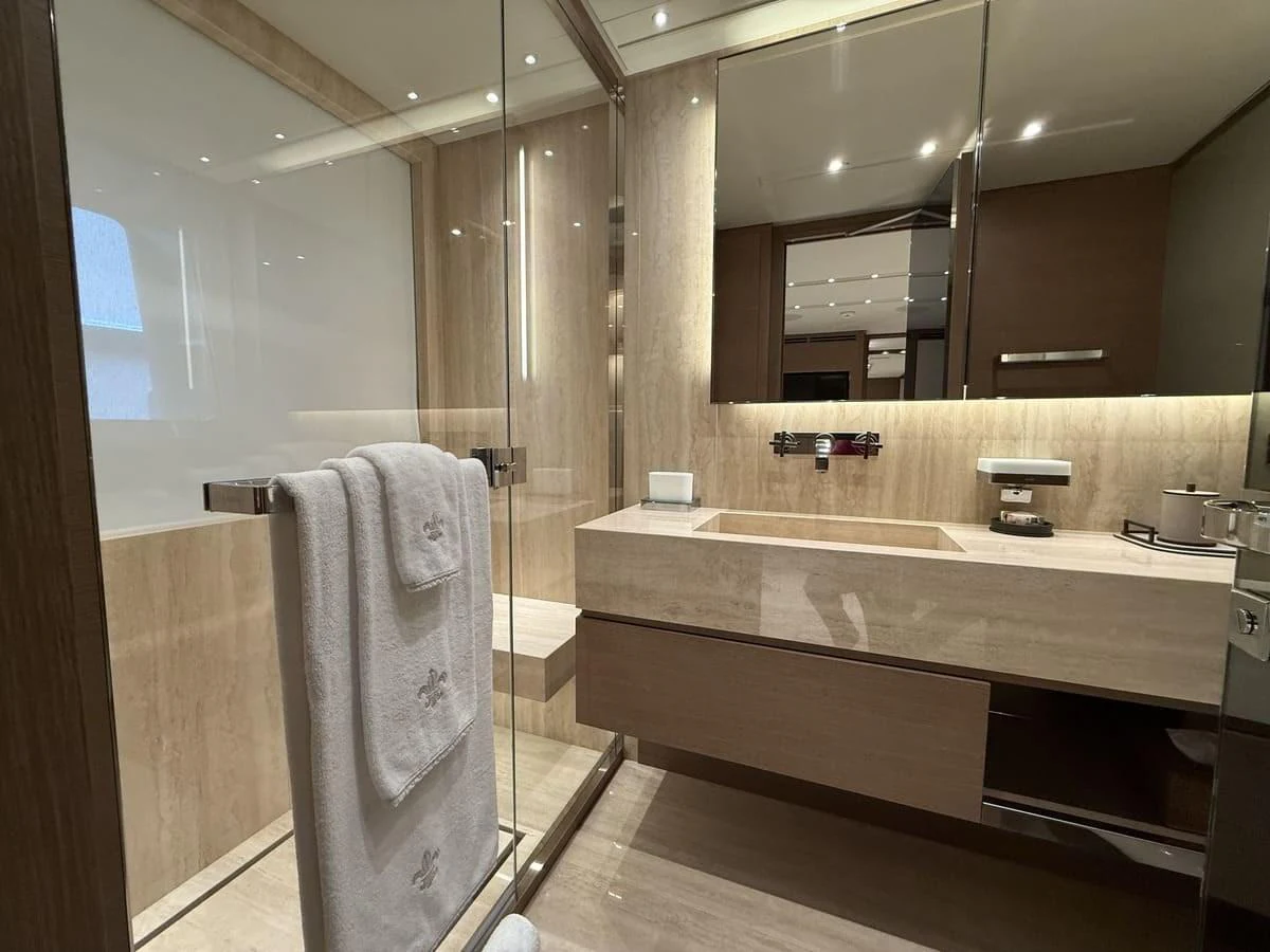 The yacht's bathroom features luxurious fixtures and a modern design with elegant lighting. aboard PHOENICIAN Yacht for Sale