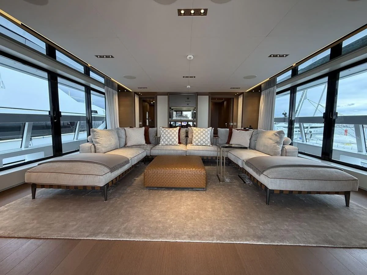 The yacht's salon features a spacious and elegant seating area with large windows providing ample natural light. aboard PHOENICIAN Yacht for Sale