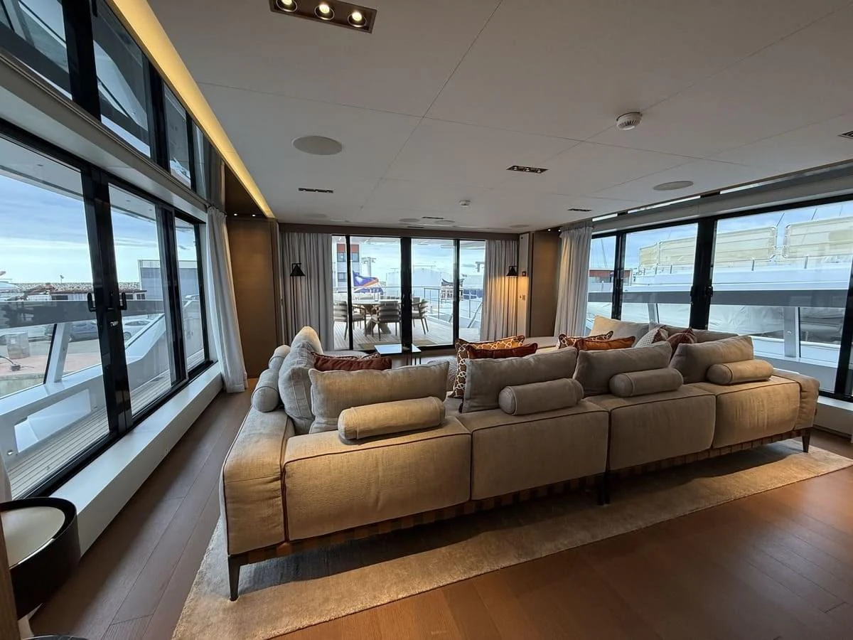 The salon features a spacious and comfortable seating area with large windows offering panoramic views. aboard PHOENICIAN Yacht for Sale