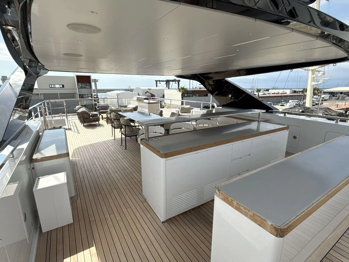 The spacious sundeck features ample seating and dining areas under a sleek, modern canopy. aboard PHOENICIAN Yacht for Sale