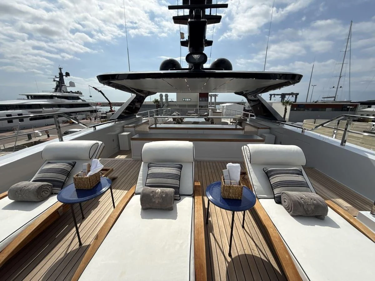 The sundeck features luxurious sun loungers with plush cushions and elegant side tables, perfect for relaxation. aboard PHOENICIAN Yacht for Sale