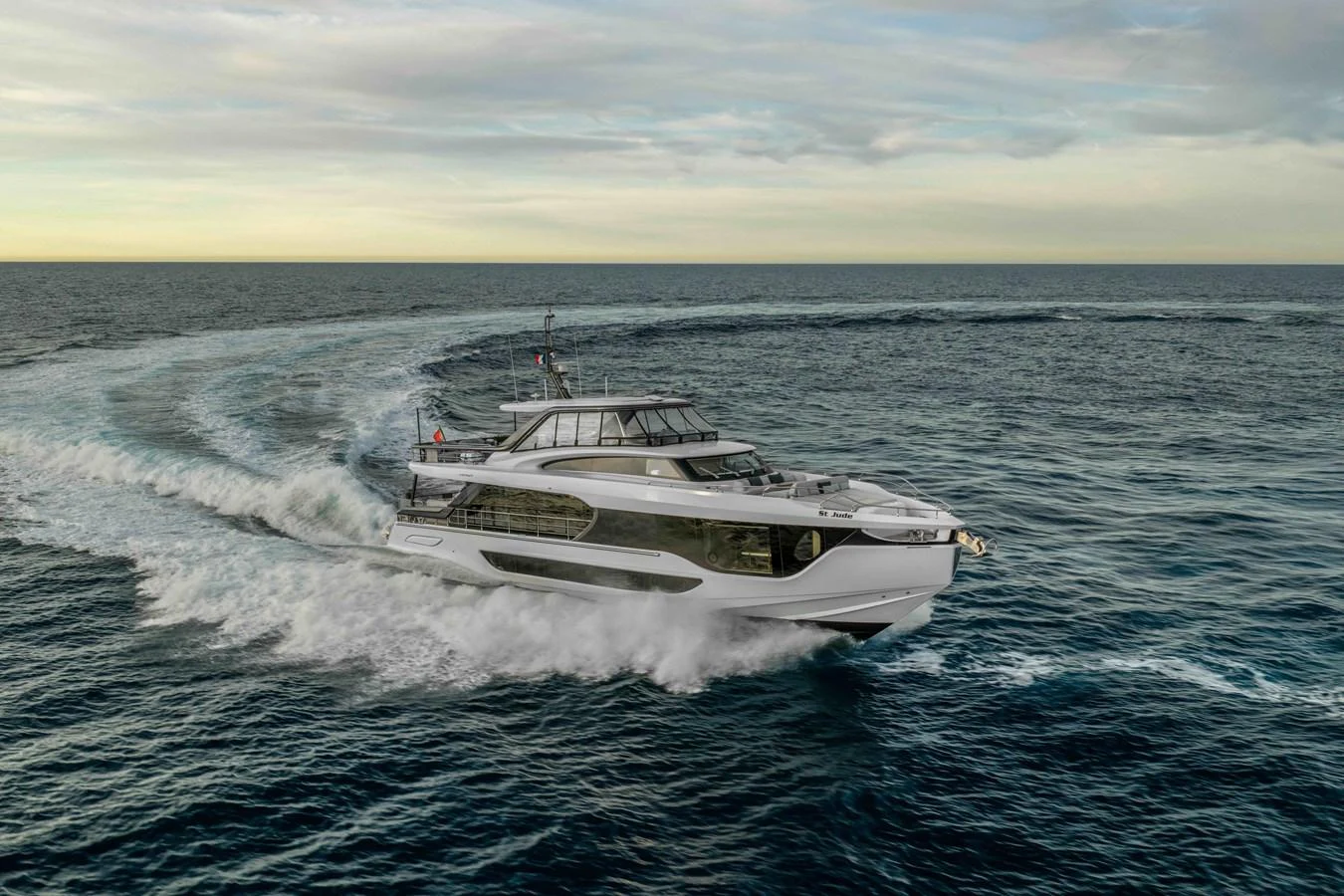 A sleek yacht cruises swiftly through open waters, showcasing its modern design and powerful performance. aboard ST JUDE Yacht for Sale