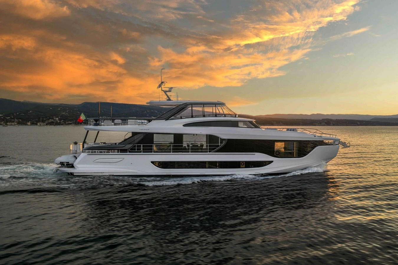 A sleek yacht cruises through calm waters at sunset, showcasing its elegant design. aboard ST JUDE Yacht for Sale