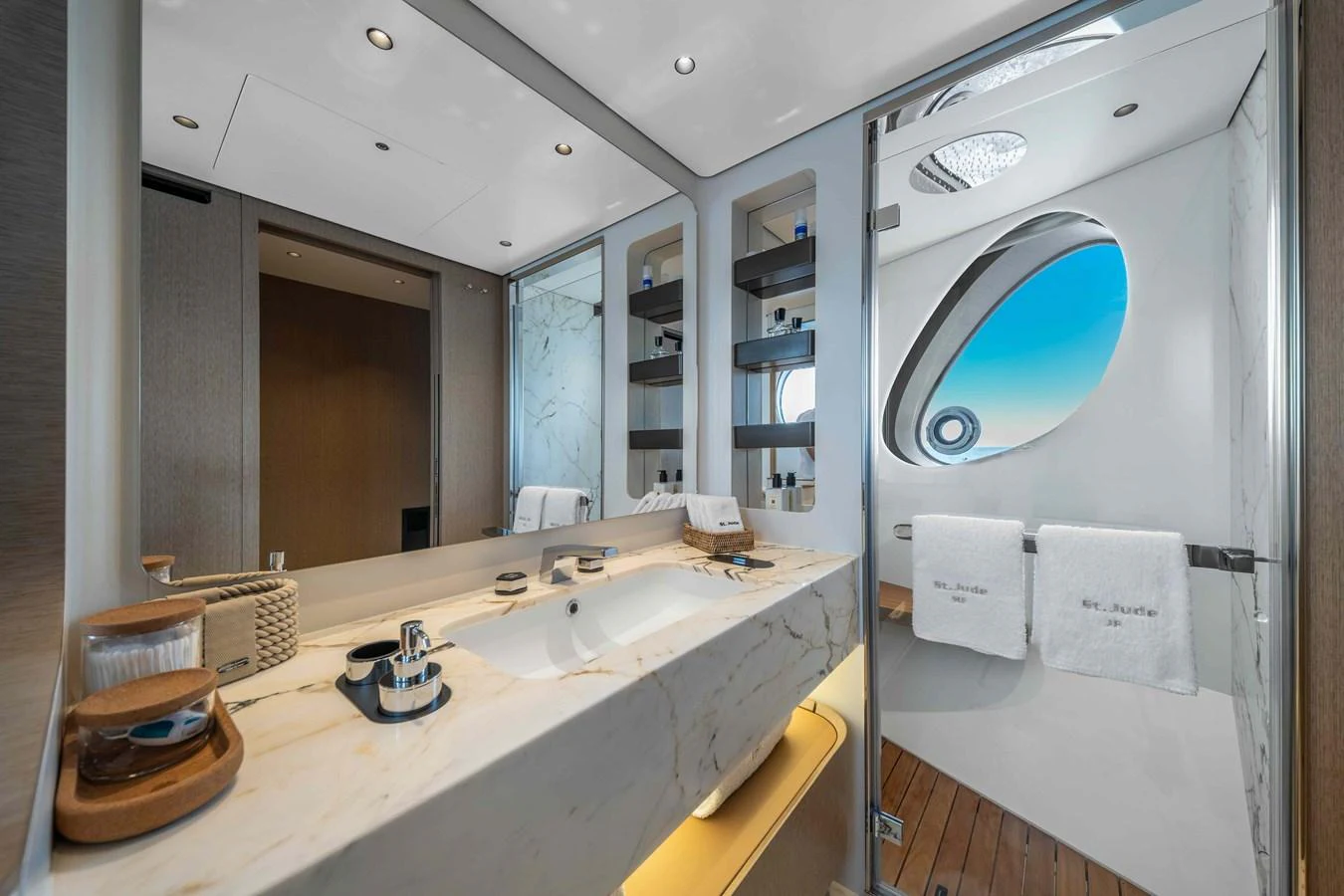 A luxurious bathroom with a large marble countertop and modern fixtures. aboard ST JUDE Yacht for Sale
