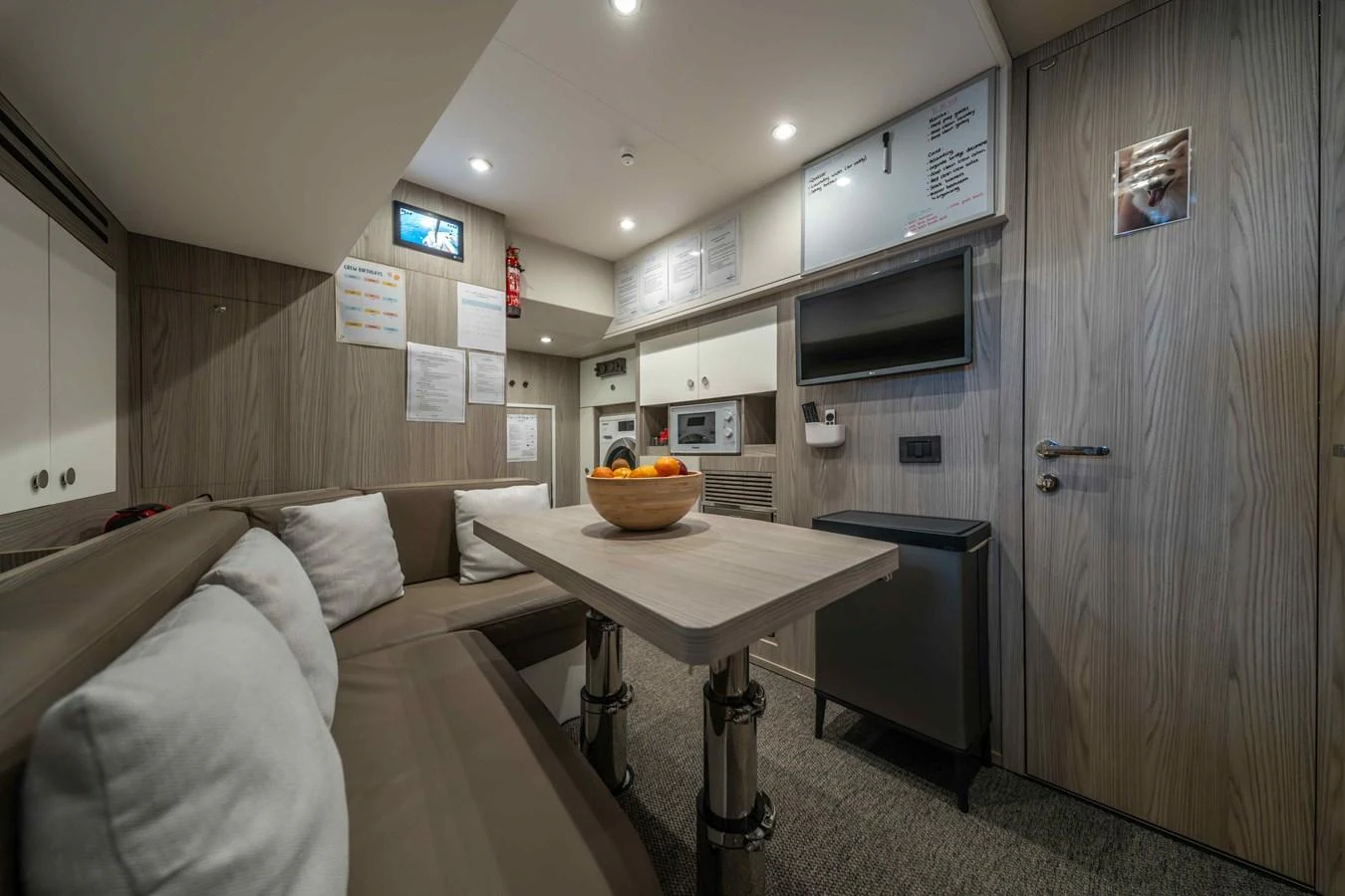 The yacht's interior features a cozy dining area with a table and comfortable seating. aboard ST JUDE Yacht for Sale
