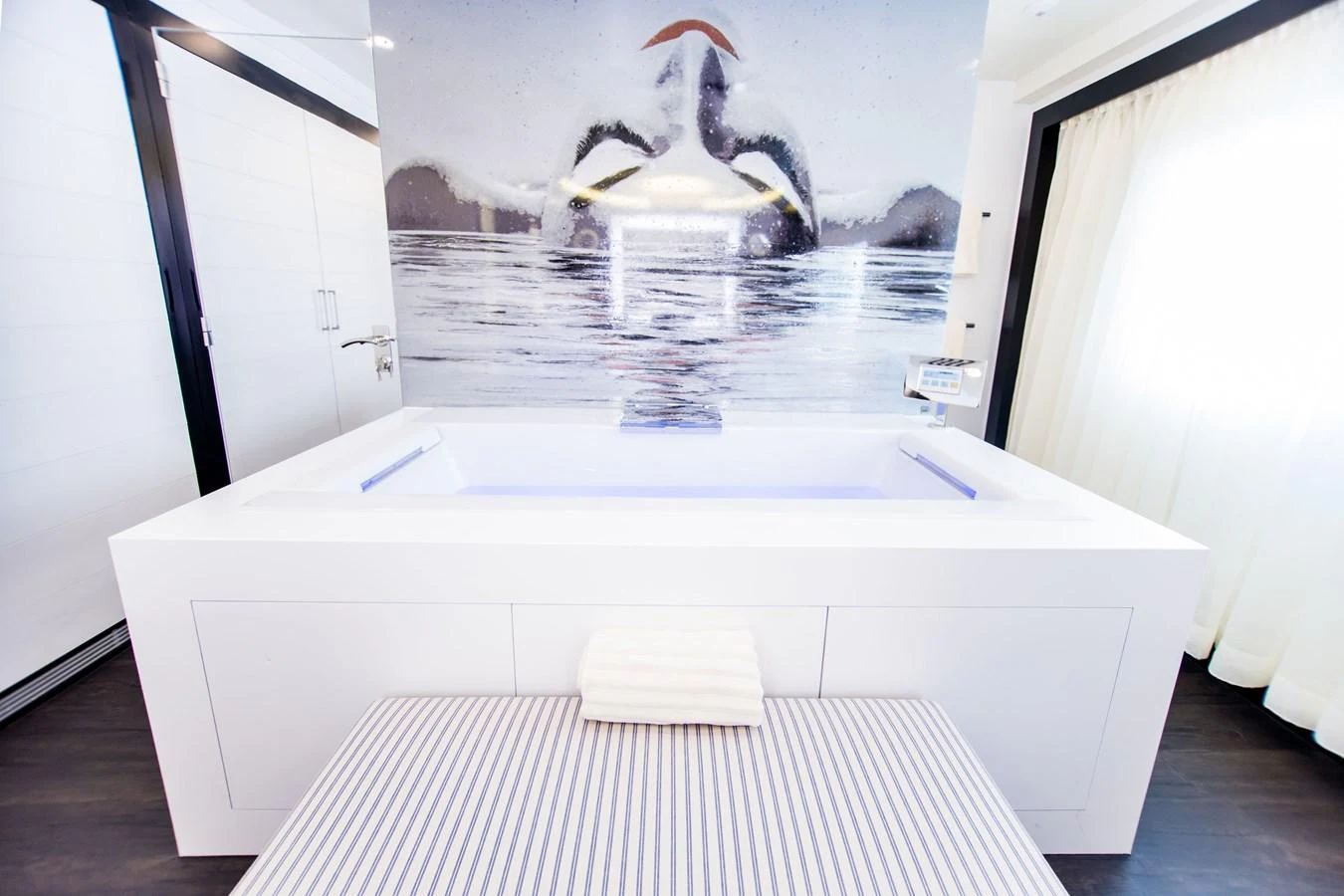 A luxurious yacht bathroom featuring a modern bathtub and stylish decor. aboard SALUZI Yacht for Sale