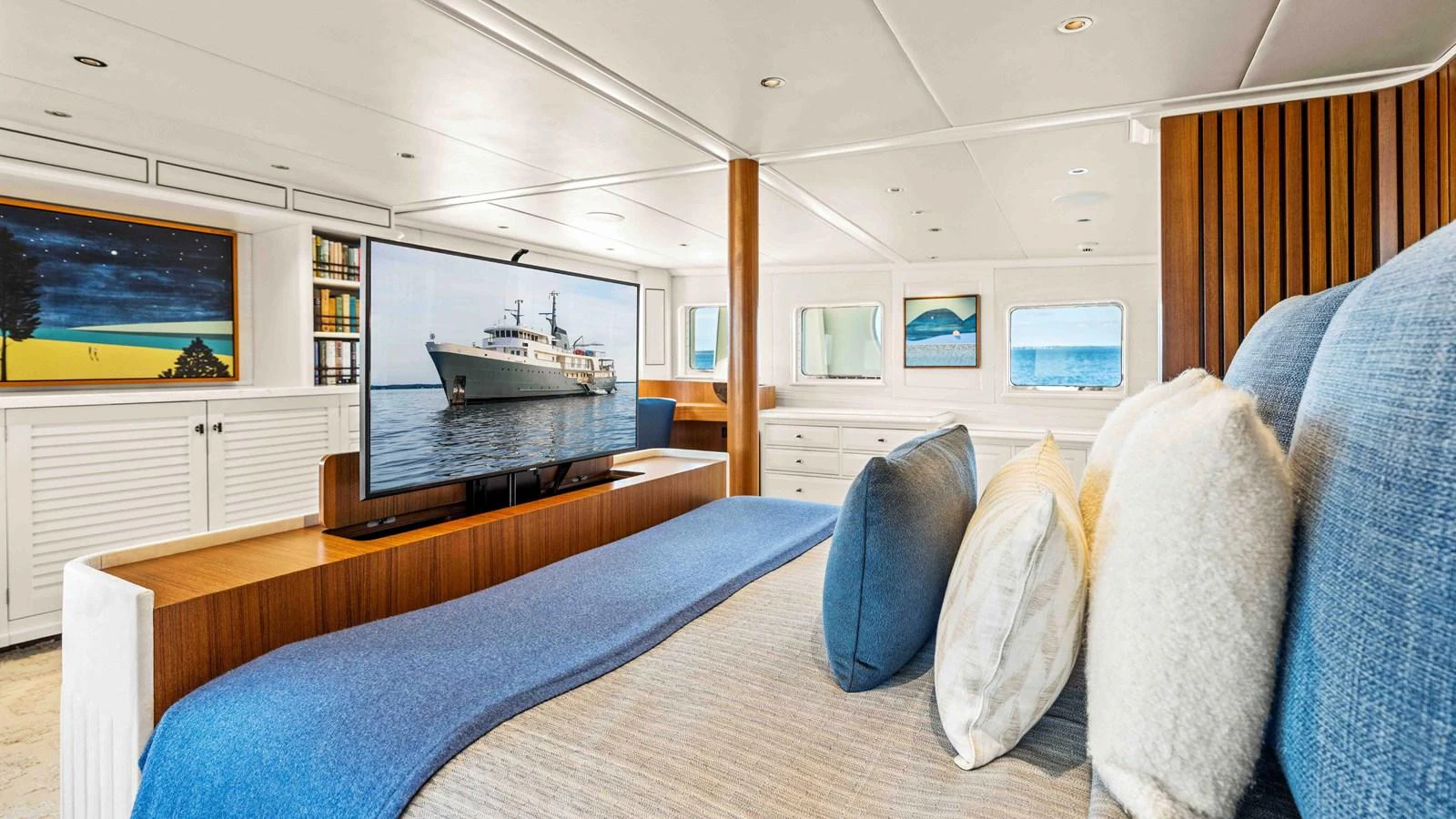 The master stateroom features a luxurious bed with a large TV and elegant decor. aboard JUST B Yacht for Sale