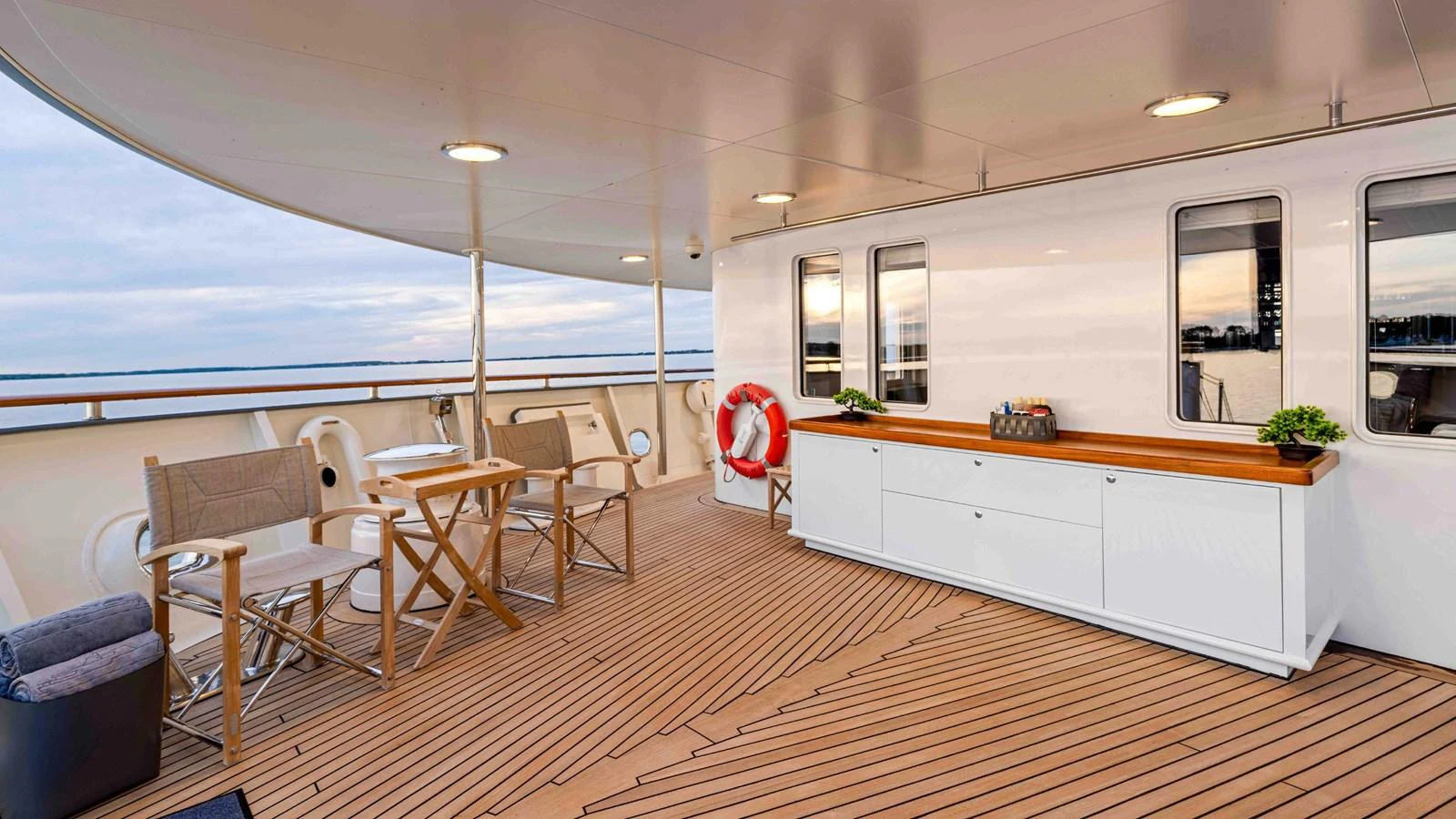The aft deck features comfortable seating and a stylish wooden table, perfect for relaxing and enjoying the view. aboard JUST B Yacht for Sale
