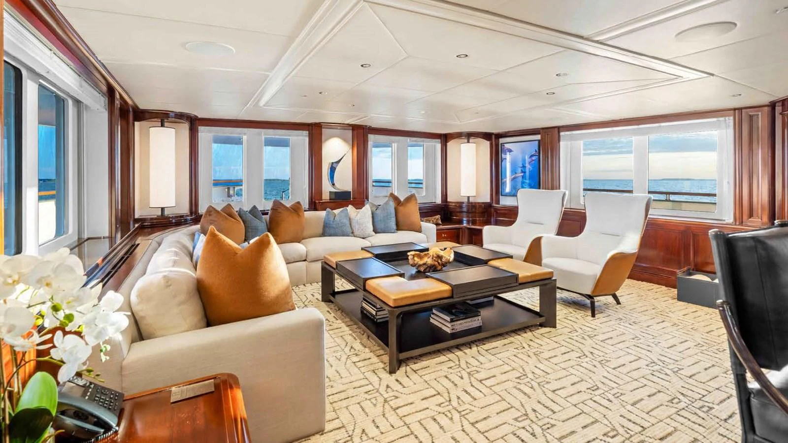 The salon features elegant seating with panoramic ocean views. aboard JUST B Yacht for Sale