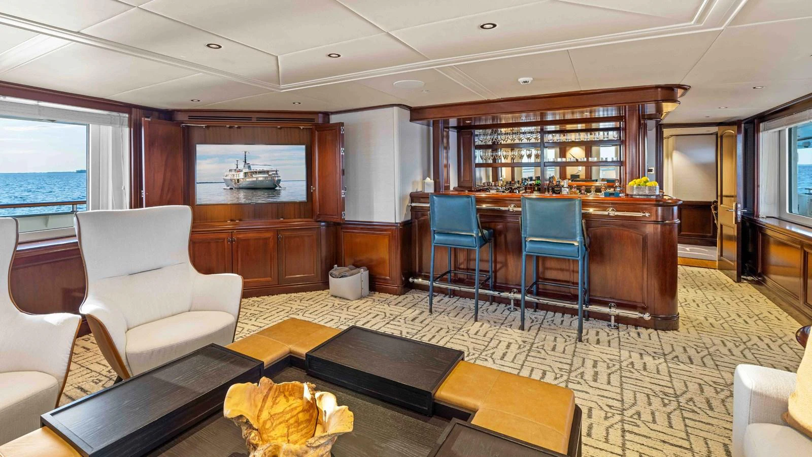 The yacht's salon features elegant seating, a sophisticated bar area, and large windows offering stunning sea views. aboard JUST B Yacht for Sale