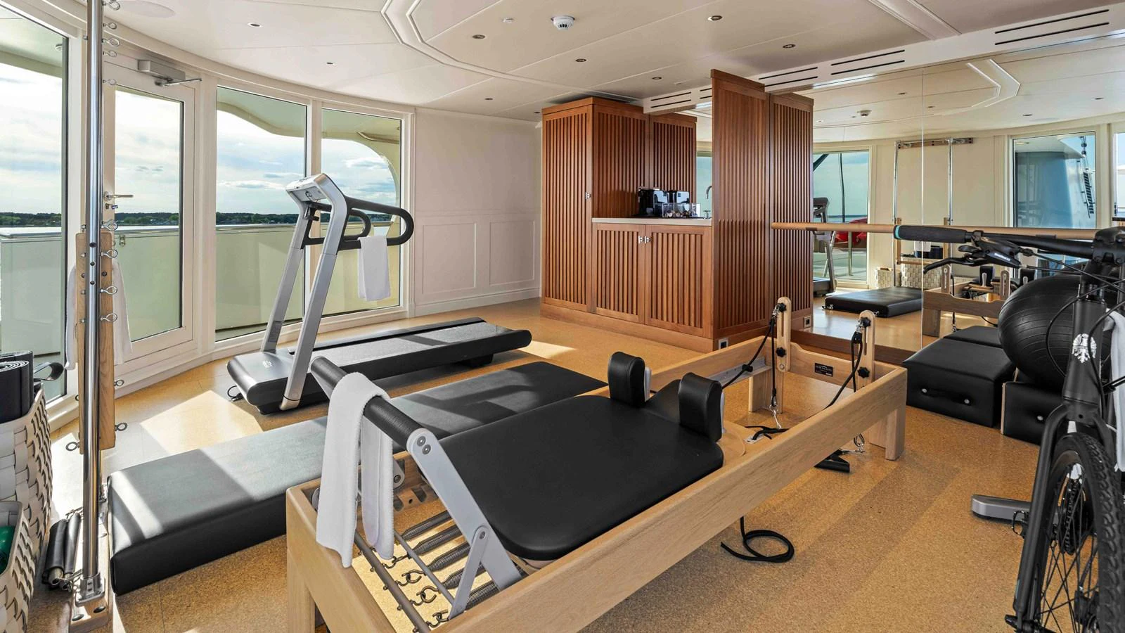 The yacht features a well-equipped gym with modern fitness equipment and ample natural light. aboard JUST B Yacht for Sale